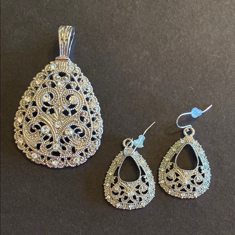 Premier Jewelry silver tone pendant with matching earrings.